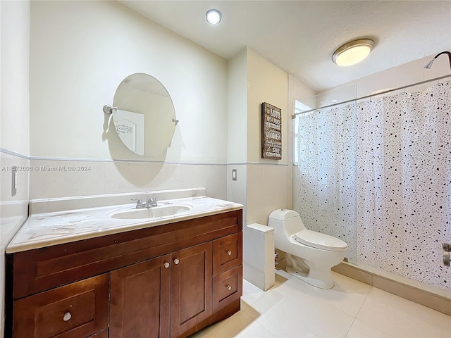 bathroom with tile patterned flooring, vanity, toilet, and walk in shower