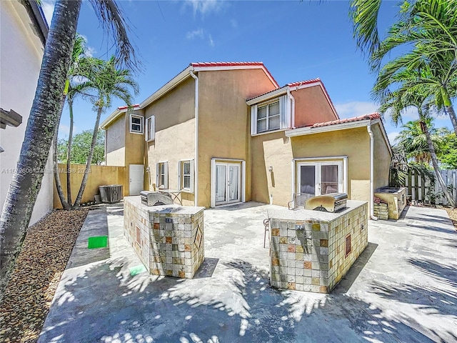 rear view of house featuring area for grilling, a patio area, and central AC