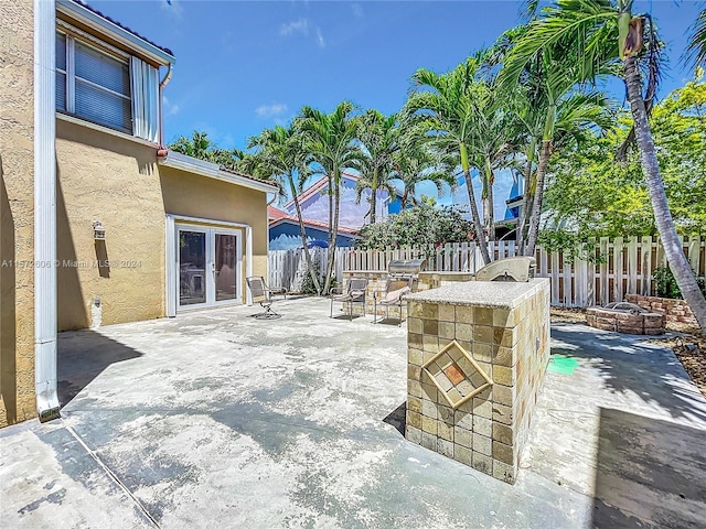 view of patio with french doors and a fire pit