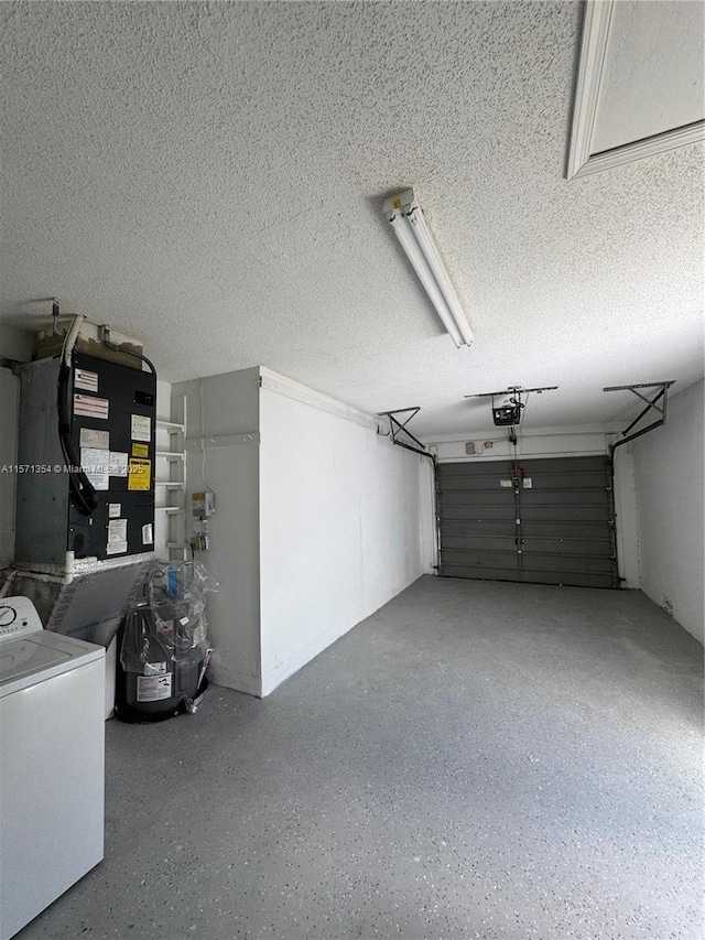 garage with washer / dryer and a garage door opener