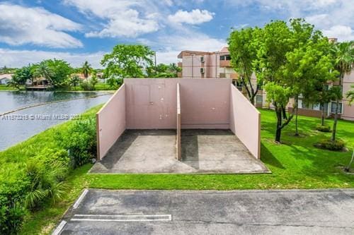 exterior space featuring a yard and a water view