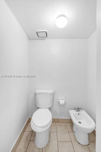 bathroom featuring a bidet, tile patterned floors, and toilet