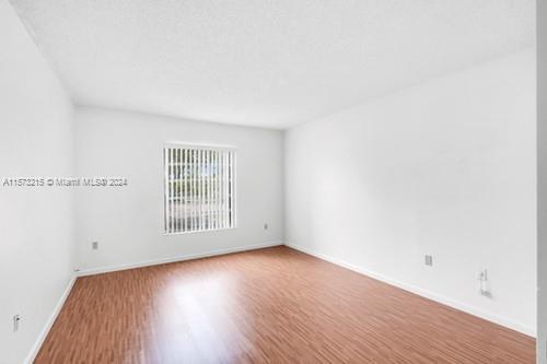 spare room featuring hardwood / wood-style floors