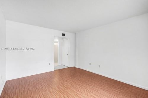 spare room with hardwood / wood-style flooring