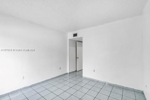 empty room with light tile patterned floors