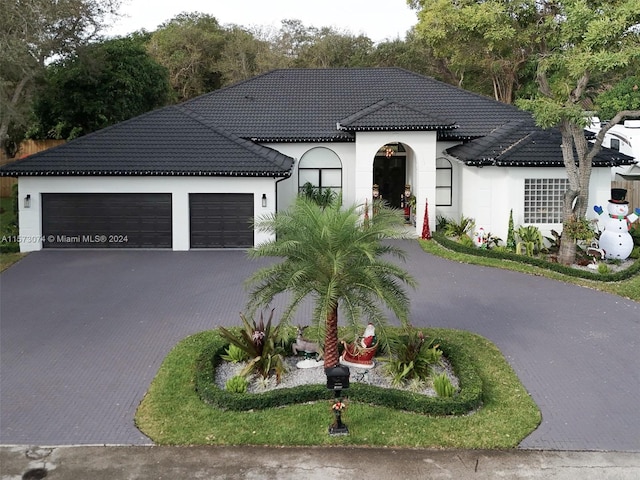 mediterranean / spanish-style home with a garage