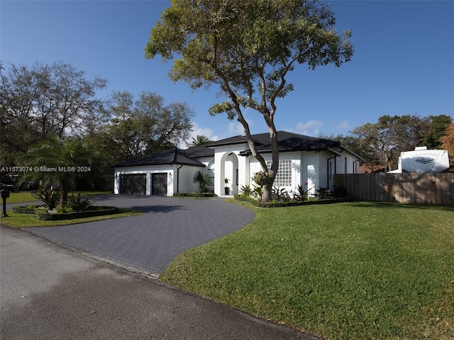 view of front facade with a garage and a front lawn