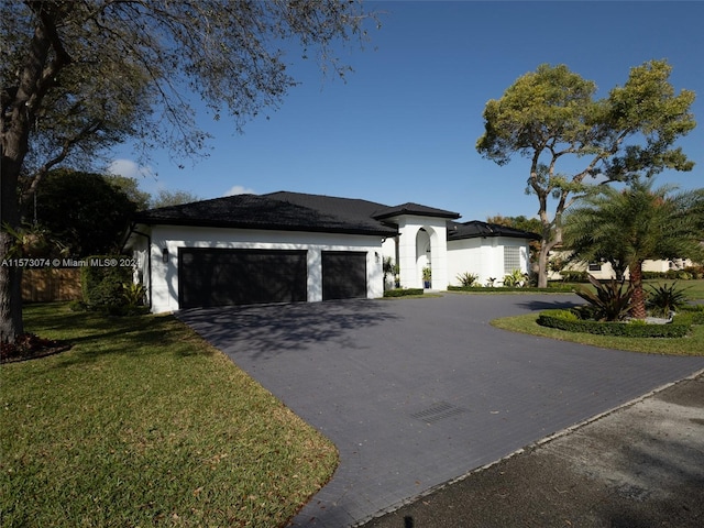 view of front facade featuring a front yard and a garage