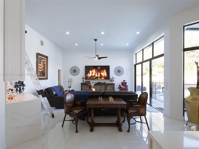 dining space with ceiling fan and light tile floors