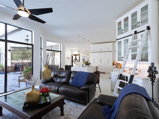 tiled living room featuring ceiling fan