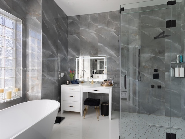 bathroom with shower with separate bathtub, tile flooring, tile walls, and large vanity