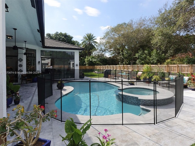 view of swimming pool featuring a patio area and an in ground hot tub