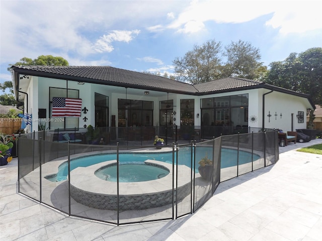 view of pool with a patio and an in ground hot tub