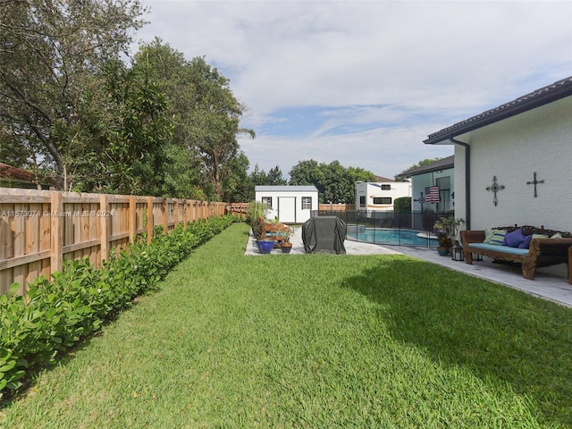 view of yard with a fenced in pool and a storage shed