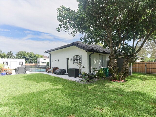 back of house with a lawn