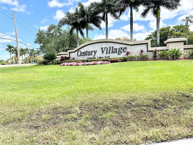 community / neighborhood sign featuring a lawn