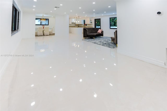 hall with light tile patterned floors