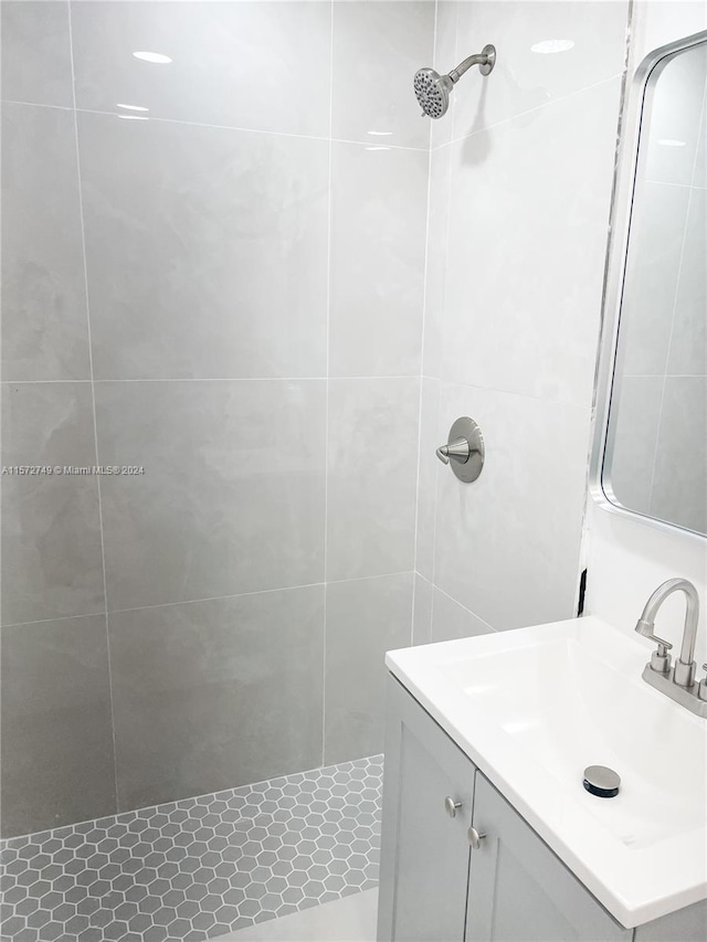 bathroom with vanity and a tile shower