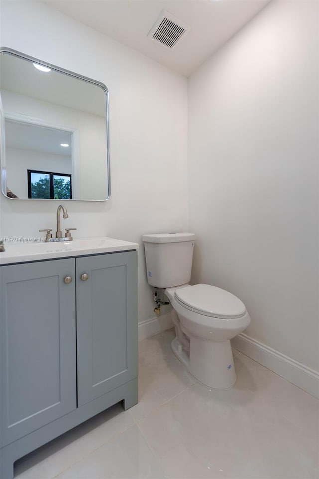 bathroom featuring vanity, toilet, and tile patterned flooring