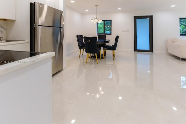 dining space featuring a chandelier and light tile patterned floors