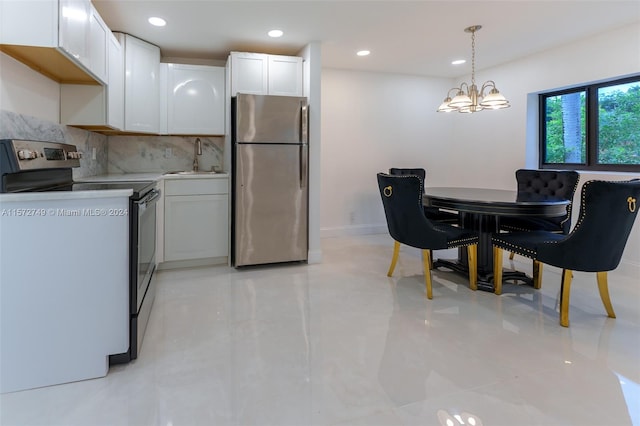 kitchen featuring pendant lighting, white cabinetry, and stainless steel appliances