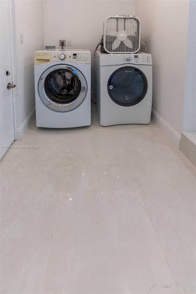 clothes washing area featuring washer and clothes dryer