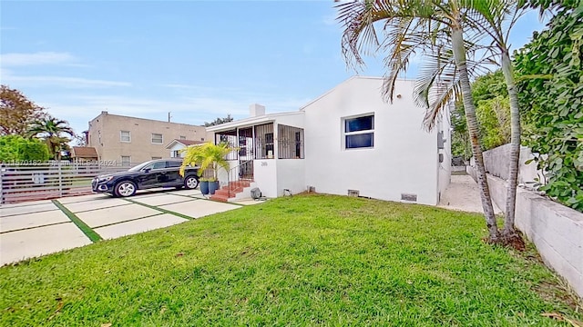 rear view of property with a lawn