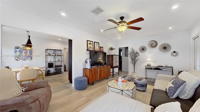 living room featuring light hardwood / wood-style flooring and ceiling fan