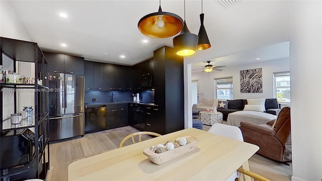 kitchen featuring ceiling fan, light hardwood / wood-style floors, dishwasher, stainless steel fridge, and sink