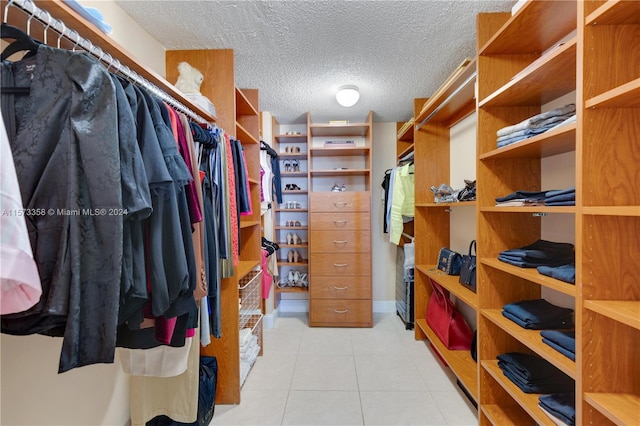 spacious closet featuring light tile patterned floors