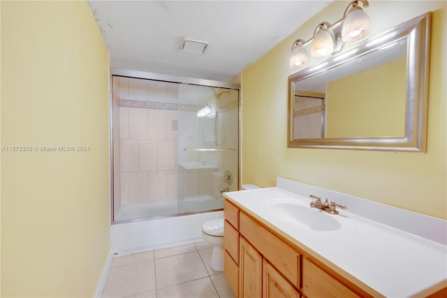 full bathroom featuring vanity, toilet, tile patterned floors, and combined bath / shower with glass door