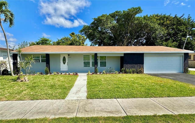 ranch-style home with a front yard and a garage