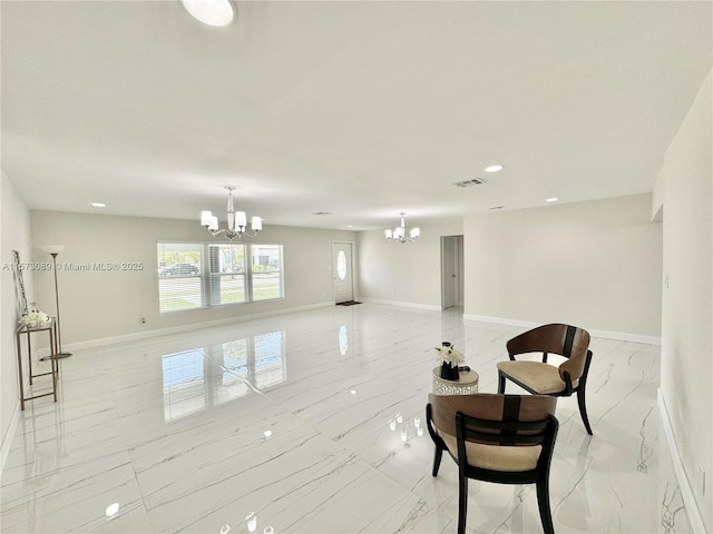 living area featuring a chandelier