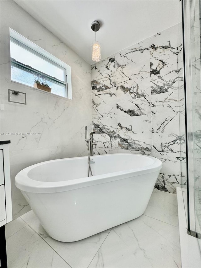 bathroom with a washtub and tile walls