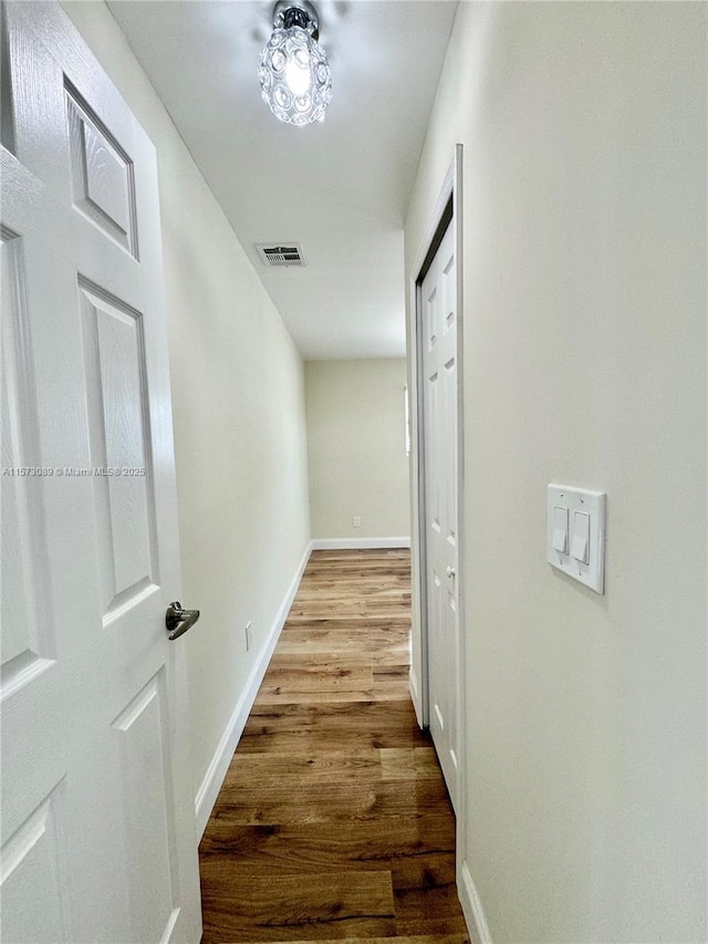 corridor with light hardwood / wood-style floors