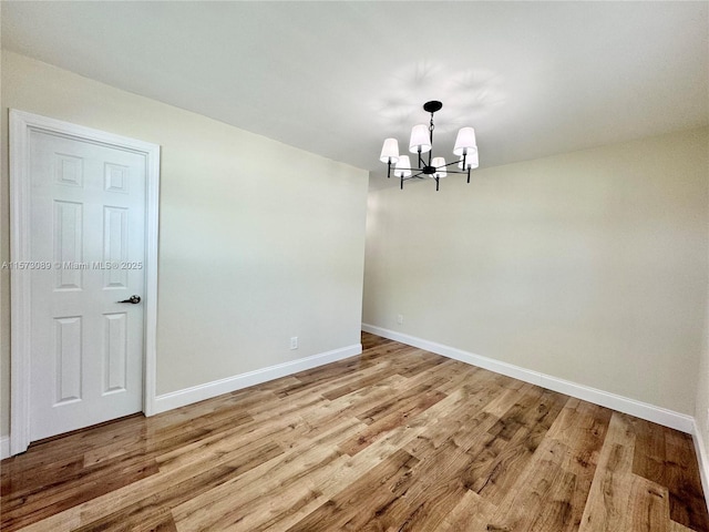 unfurnished dining area featuring light hardwood / wood-style flooring and a notable chandelier