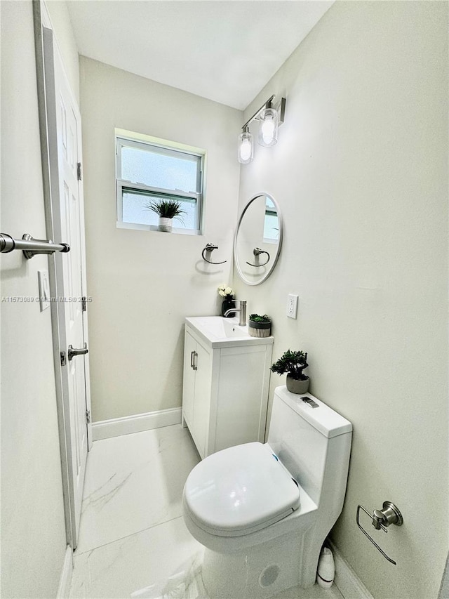 bathroom featuring toilet and vanity