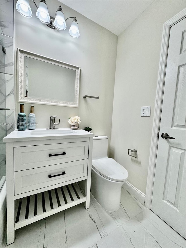 bathroom featuring toilet, vanity, and walk in shower