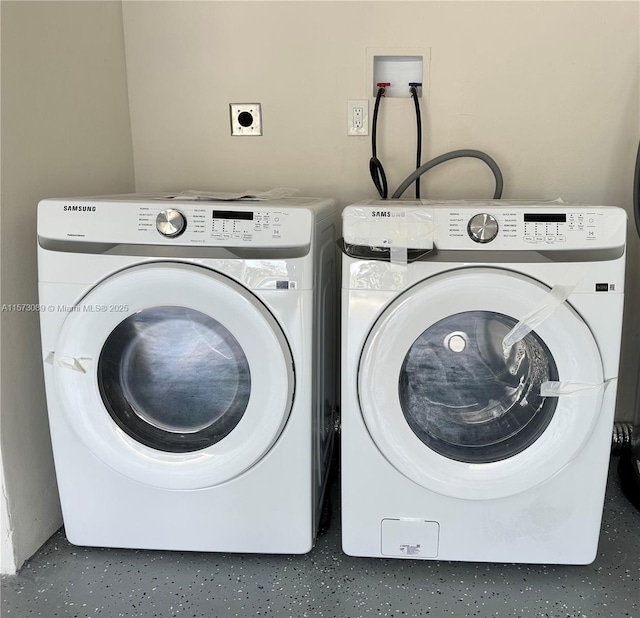 clothes washing area featuring washer and dryer