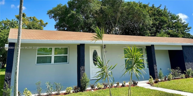 ranch-style home featuring a front yard