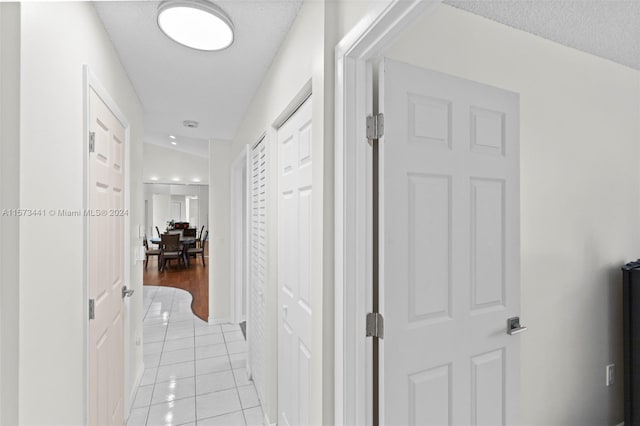 hall featuring light tile flooring