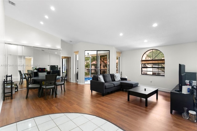 tiled living room with high vaulted ceiling