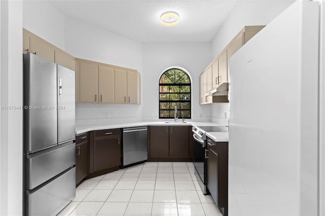 kitchen featuring dark brown cabinetry, sink, light tile floors, and stainless steel appliances