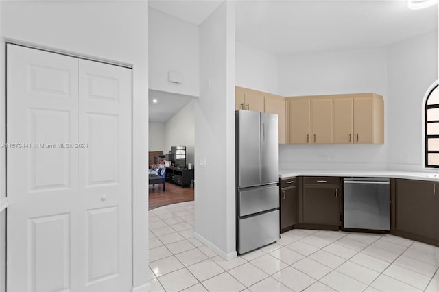 kitchen with stainless steel appliances and light tile floors