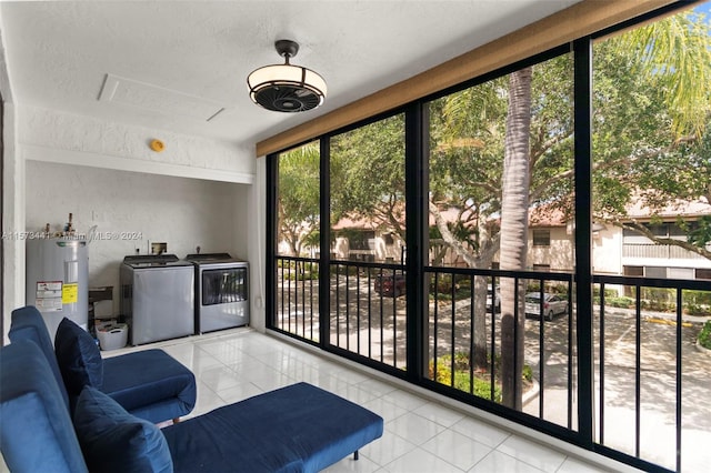 sunroom / solarium with water heater and washer and clothes dryer