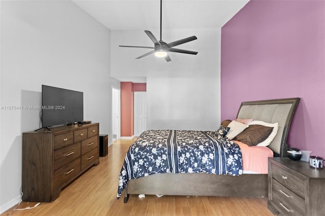 bedroom featuring ceiling fan, vaulted ceiling, and light wood-type flooring