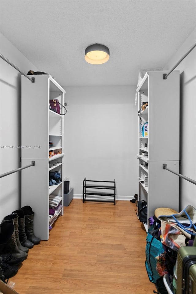 spacious closet with light hardwood / wood-style floors