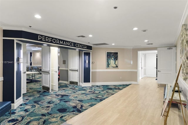 interior space featuring crown molding and light hardwood / wood-style floors