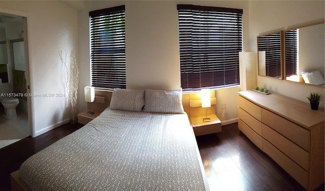 bedroom with dark hardwood / wood-style flooring