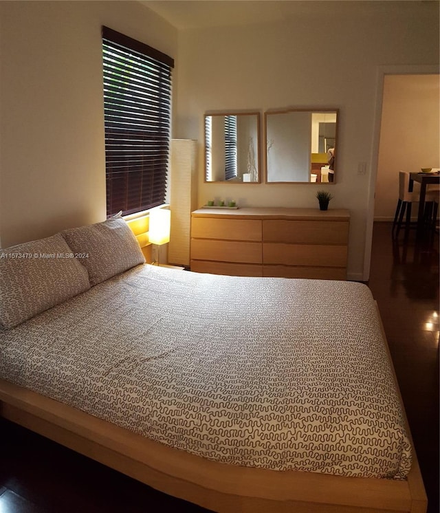 unfurnished bedroom with dark wood-type flooring